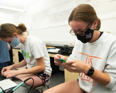 Edwardsville High School seniors Mera Rusick (back) and Madison Vieth (front) work on circuit project.