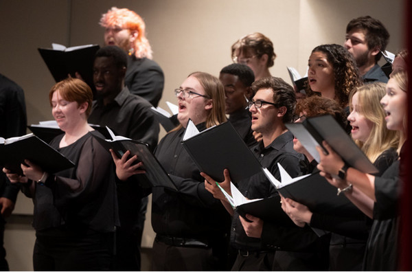 Choir singing while holding music books