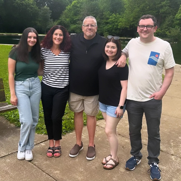 Lindy and Aaron and their family members total five people in the photo