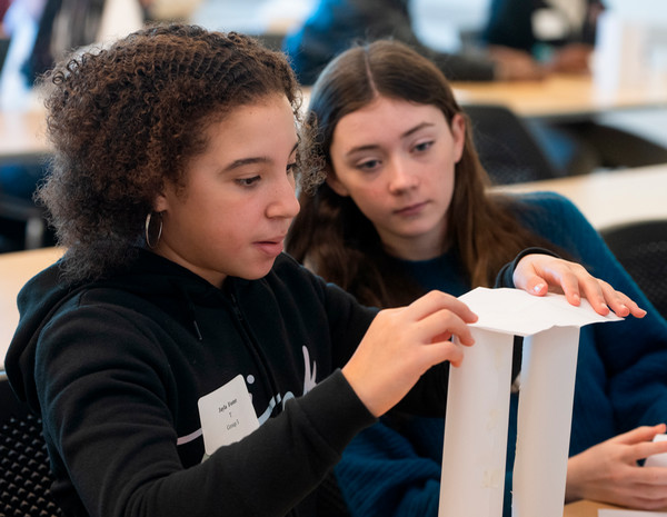 Two girls working on a table top engineering project