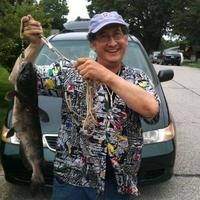 portrait of Professor Wanda holding an array of caught fish